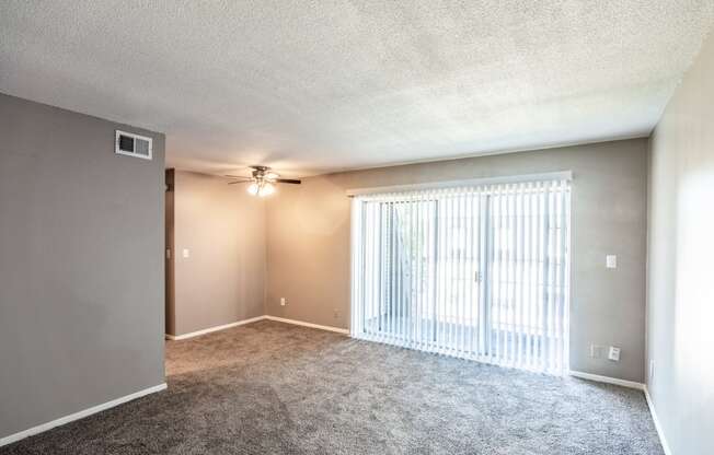 Spacious living room with carpet and big window