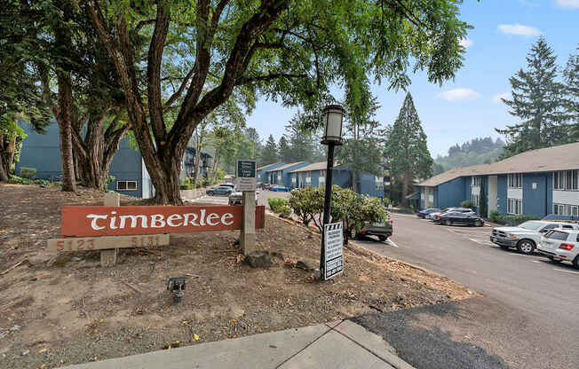 A Timberlee sign is in front of a tree.