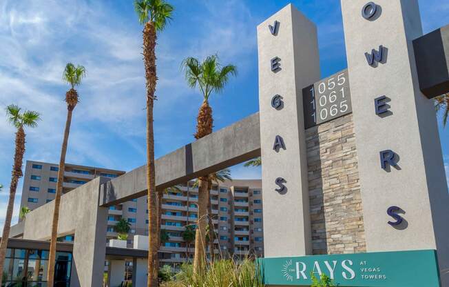 a city with palm trees in front of a building at The Rays at Vegas Towers Apartments, Las Vegas, NV