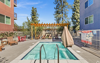 A pool area with a slide and sun loungers.