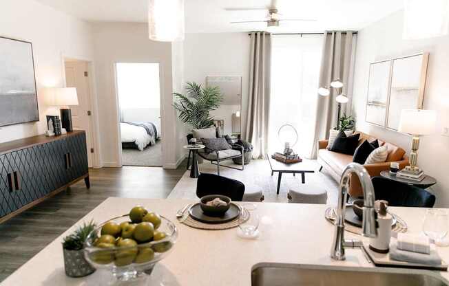 A modern kitchen with a bowl of green olives on the counter.