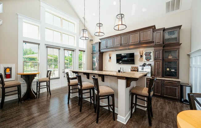a large kitchen with a large island with chairs