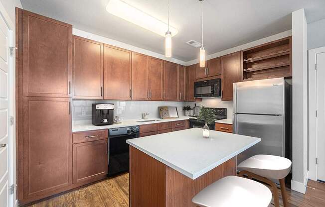 A kitchen with brown cabinets and a white island.