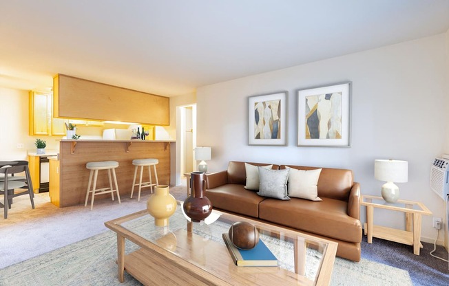 A living room with a brown couch and a coffee table at The Woods Apartments, California, 95136