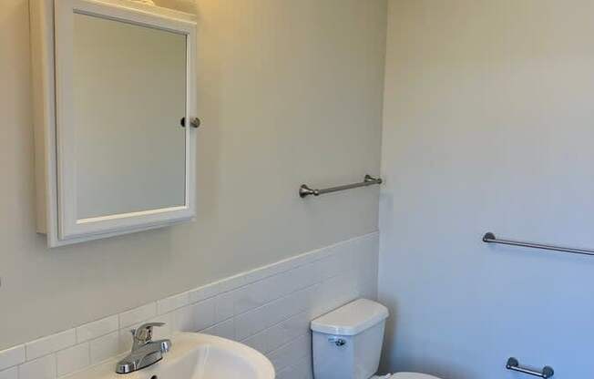 A white sink and toilet in a bathroom.