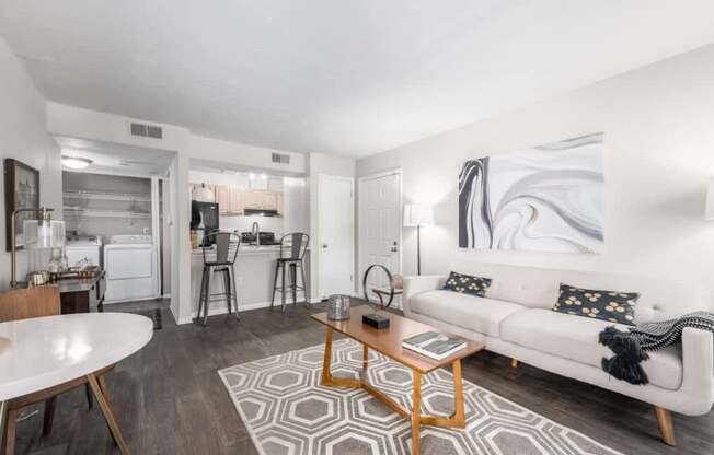 A modern living room with a white couch and a coffee table.