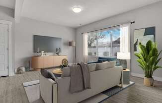 A living room with a couch, a mirror, a lamp, and a potted plant.