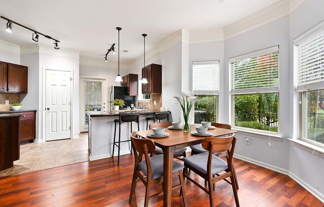 an open kitchen and dining room with a table and chairs at Sovereign at Overland Park, Overland Park  