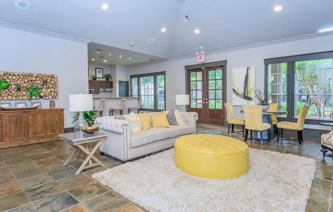 a living room filled with furniture and a large window