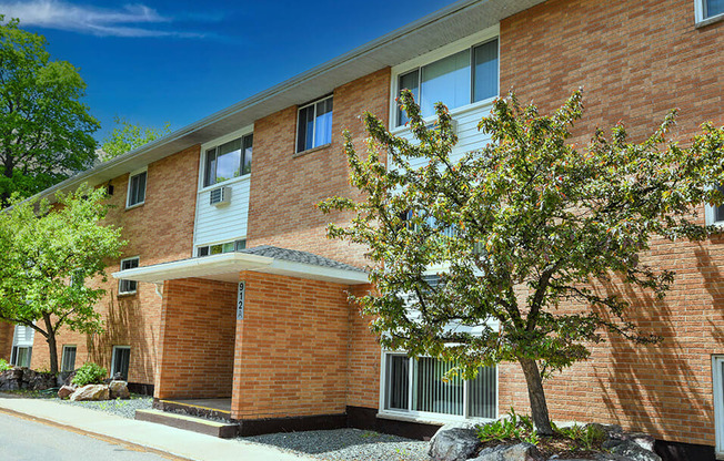 a brick building with a tree in front of it