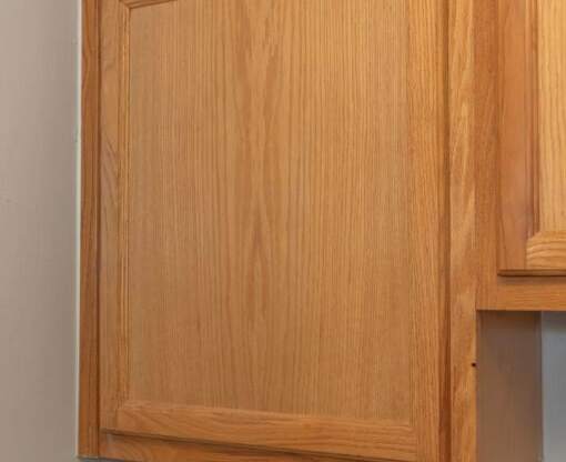 a kitchen cabinet with wooden doors on a wall