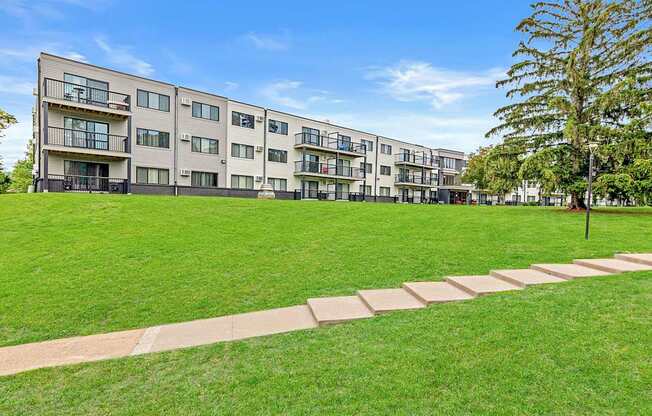 A large grassy area in front of apartment buildings.