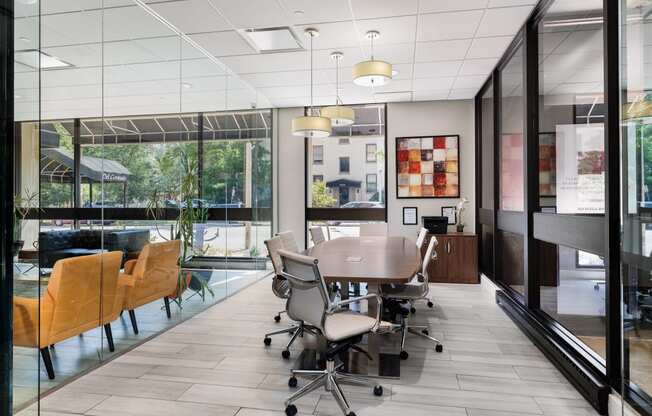 a conference room with a table and chairs in front of a window