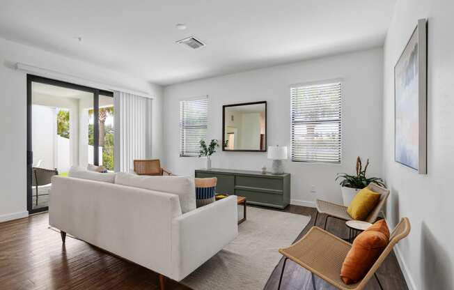 a living room with a couch and chairs and a sliding glass door at Odyssey, Florida, 33905