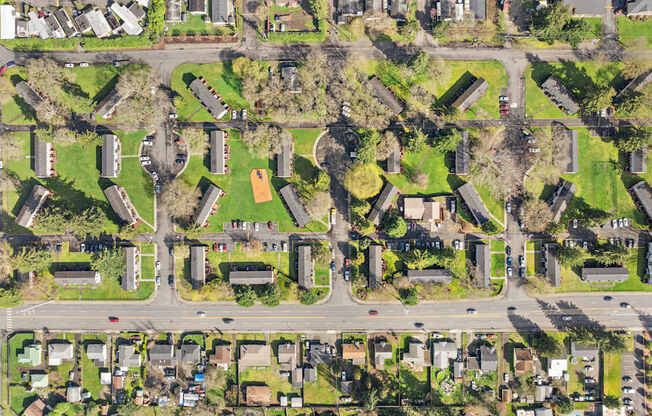 A bird's eye view of a residential area with houses and roads.