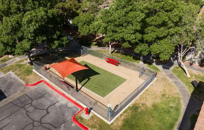 an aerial view of a park with a basketball court and a red court