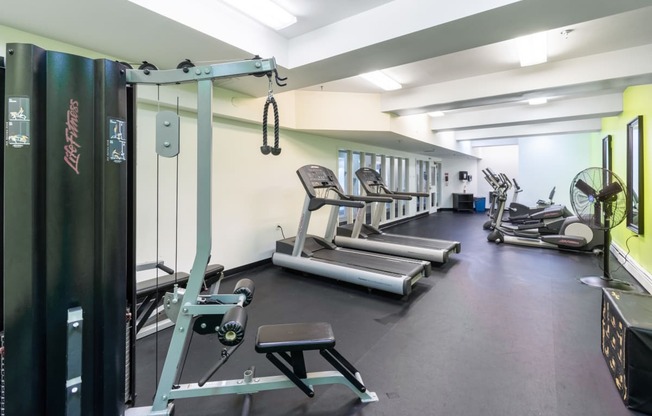 a gym with cardio equipment and weights on the floor at Royal Worcester Apartments, Massachusetts