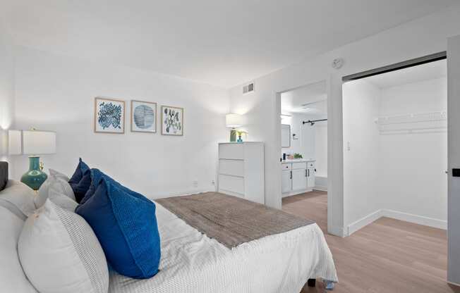 a bedroom with a bed and a closet and a bathroom