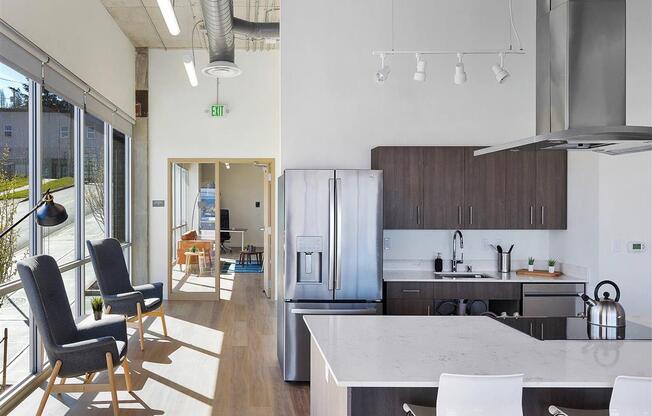 a kitchen with a refrigerator freezer next to a stove top oven at Jefferson Yards, Tacoma, 98402