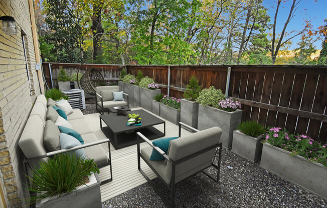 a patio with couches and chairs and a table