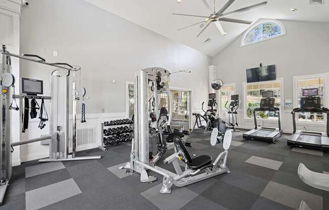 A spacious home gym with a variety of exercise equipment.
