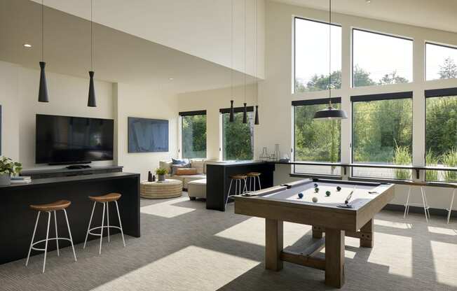 an open living room with a pool table and a flat screen tv