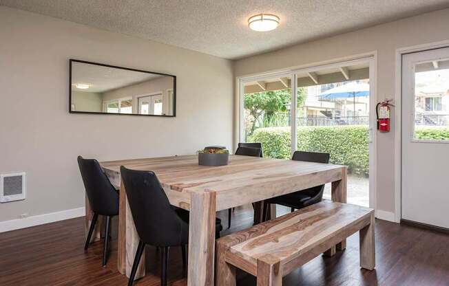 a dining room with a wooden table and chairs