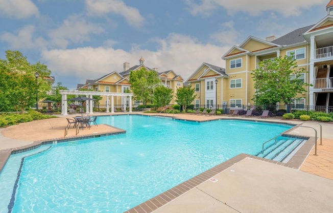 large pool and lounge area surrounded by trees and apartment homes at Fenwyck Manor