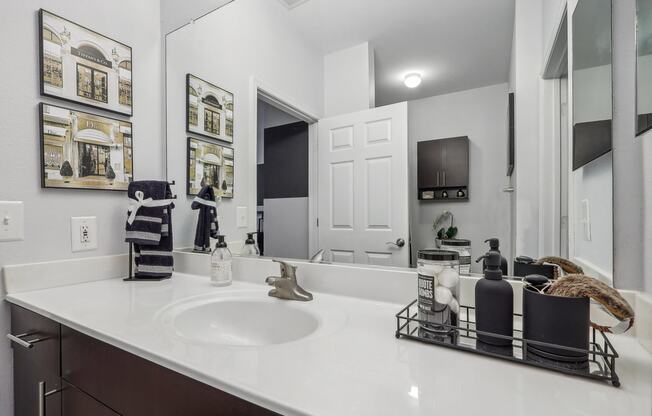 a large bathroom with a large sink and mirrors
