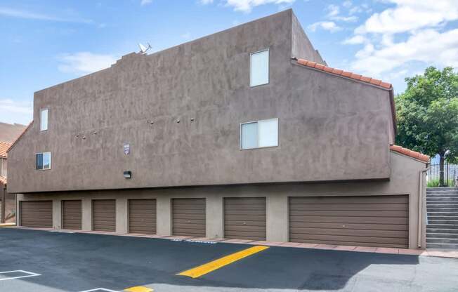 A building with a tan facade and a red tile roof.