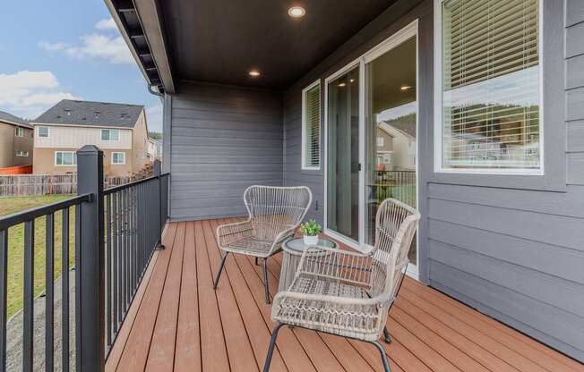 Outdoor patio with a chair and table at Thrive at Green Mountain, Camas, WA, 98607