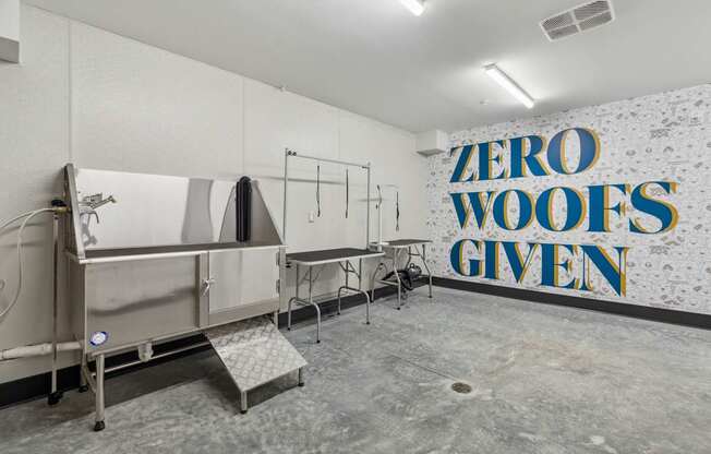 A wall with the words "Zero Woofs Given" in blue and yellow.