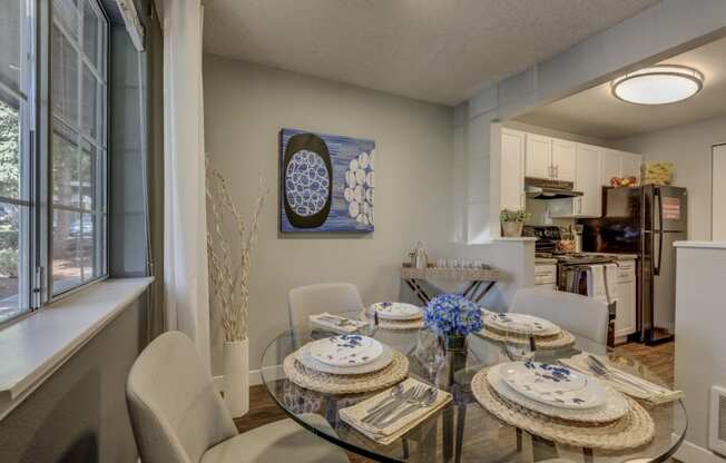 Beaverton OR Apartments - Cedar Crest - Dining Room with Glass Table and Grey Walls Leading into the Kitchen
