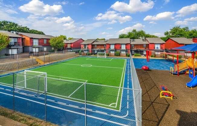 Fenced soccer field and playground  in a courtyard