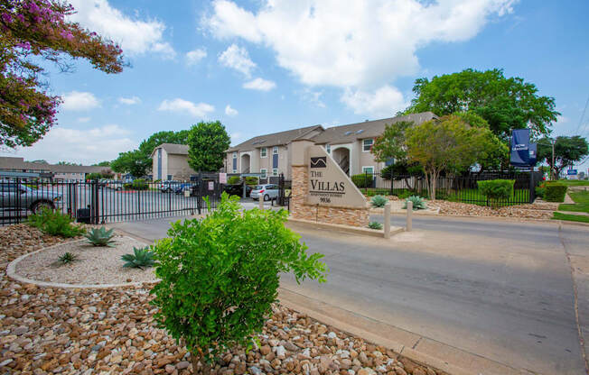 A sign that says "The Villas" is in front of a building.