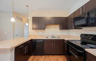 a kitchen with black appliances and a counter top