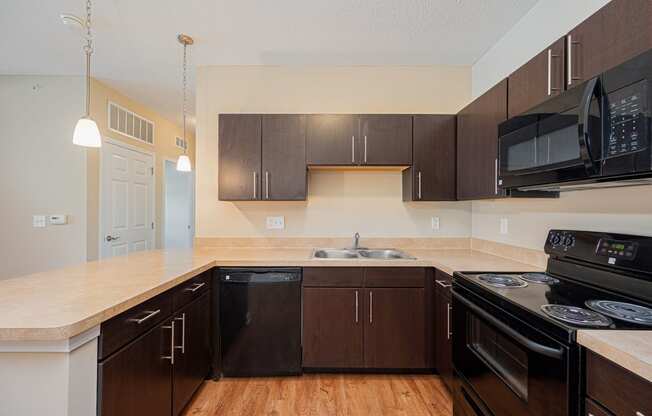 a kitchen with black appliances and a counter top