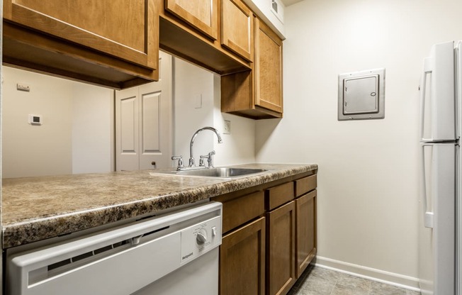 a kitchen with a sink and a dishwasher and a refrigerator at Pheasant Run in Lafayette, IN 47909