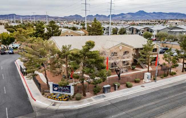 A street view of a residential area with a sign that reads "Pearl".