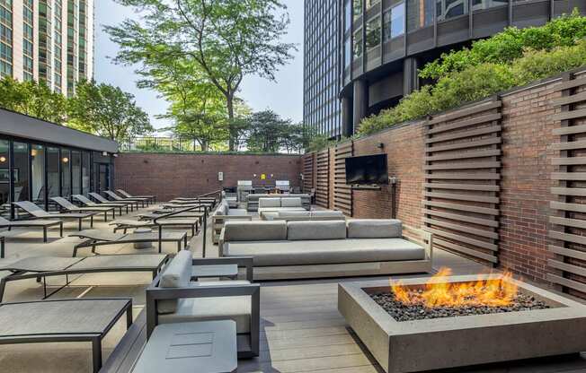 a lounge area with couches and tables and a fire pit at North Harbor Tower, Illinois
