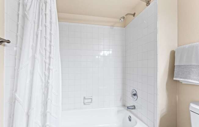 a bathroom with a shower and a tub and a sink