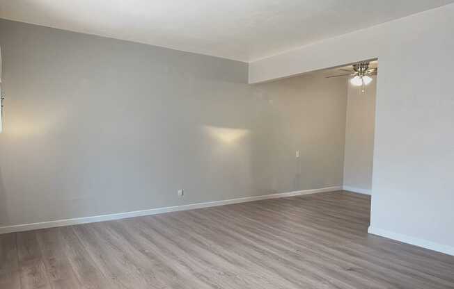 A room with light grey walls and wooden flooring.