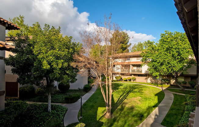 Property View With Mature Tree, cloud in sky at Wilbur Oaks Apartments, California, 91360