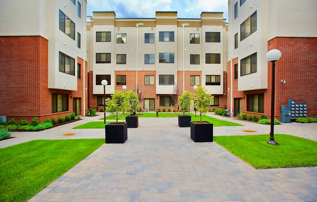The Lofts at Middlesex courtyard view with green grass, beautiful plants, a quiet place to relax