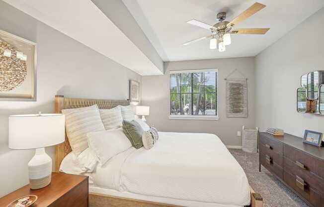 a bedroom with a large bed and a ceiling fan