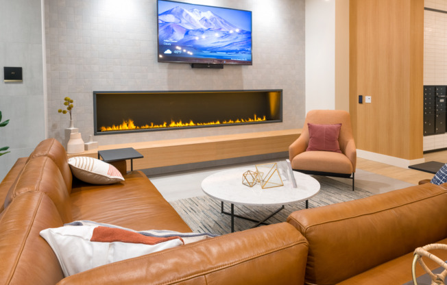 Relax on leather sofas in front of a modern gas fireplace
