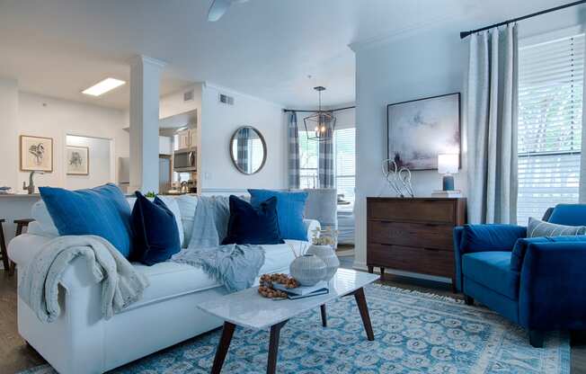 Livingroom with white couch and a blue chair