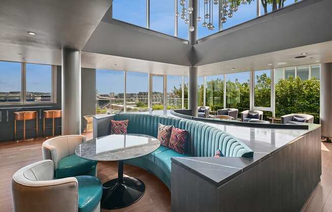 A modern lounge area with a curved sofa and a round table.