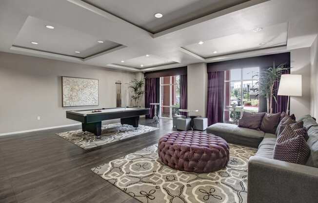 a living room filled with furniture and a pool table