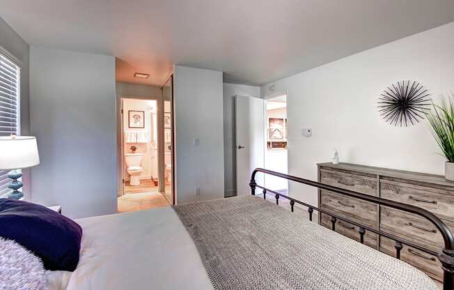 Kirkland WA Apartments-Woodlake Apartments Carpeted Bedroom With Bedside Tables And Window And Plush Bedding Woodlake Bedroom